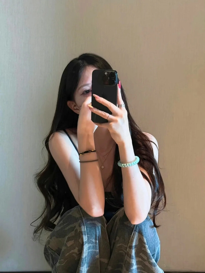 Hot girl cầm điện thoại che mặt tự nhiên